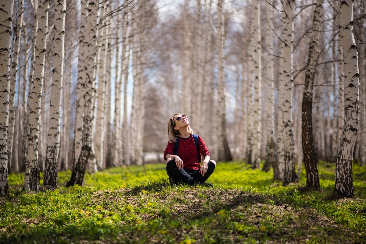 woman sitting outside in aspen trees woman sitting outside in aspen trees